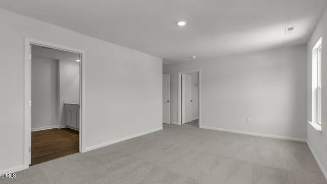 a view of an empty room and closet area