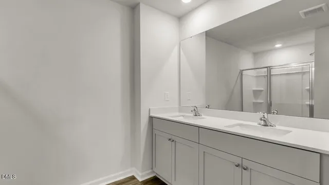 a bathroom with 2 sink and a mirror