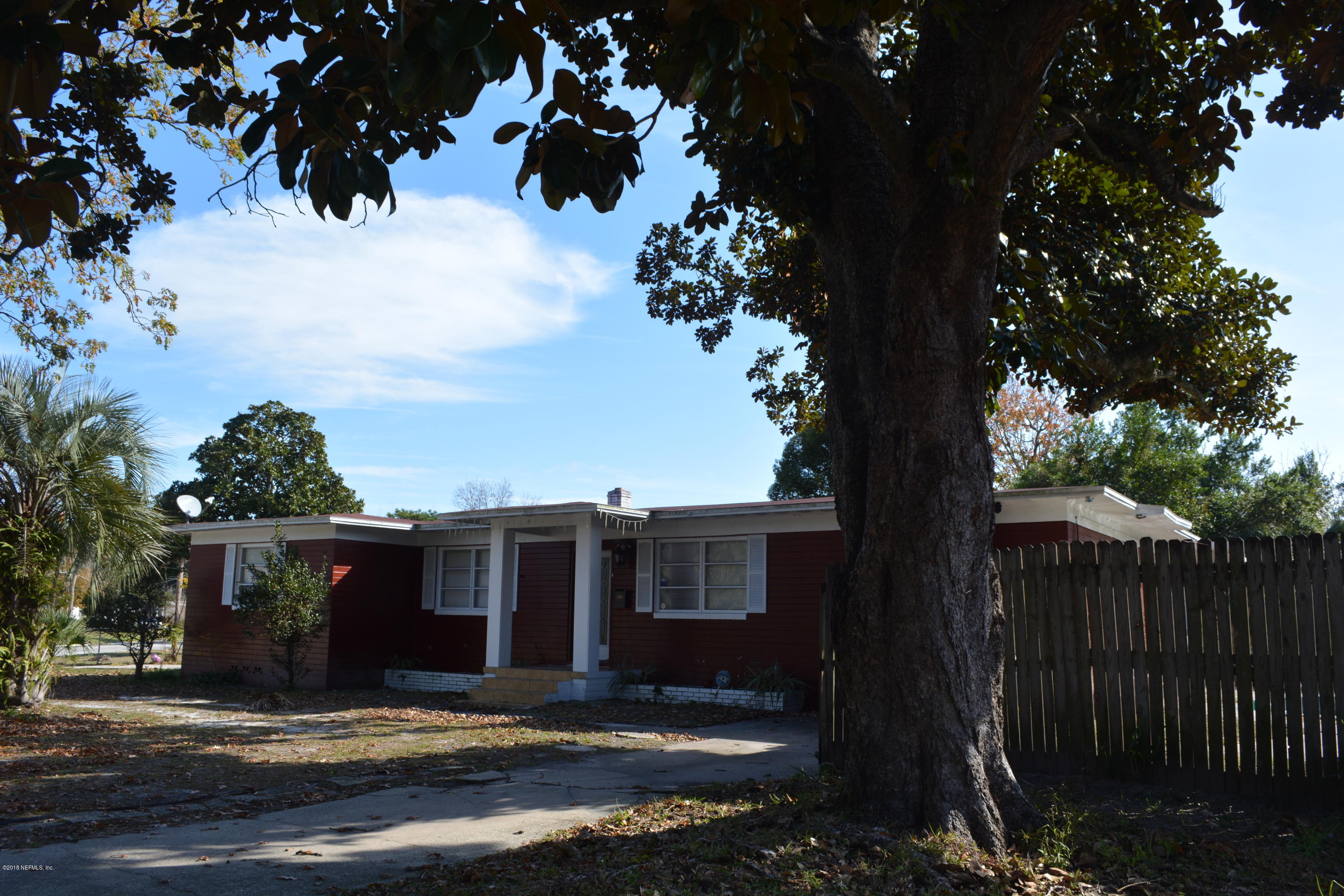 3235 Rogero Road Jacksonville, FL 32277 - Photo 1 of 20 a view of a house with a tree in front of it