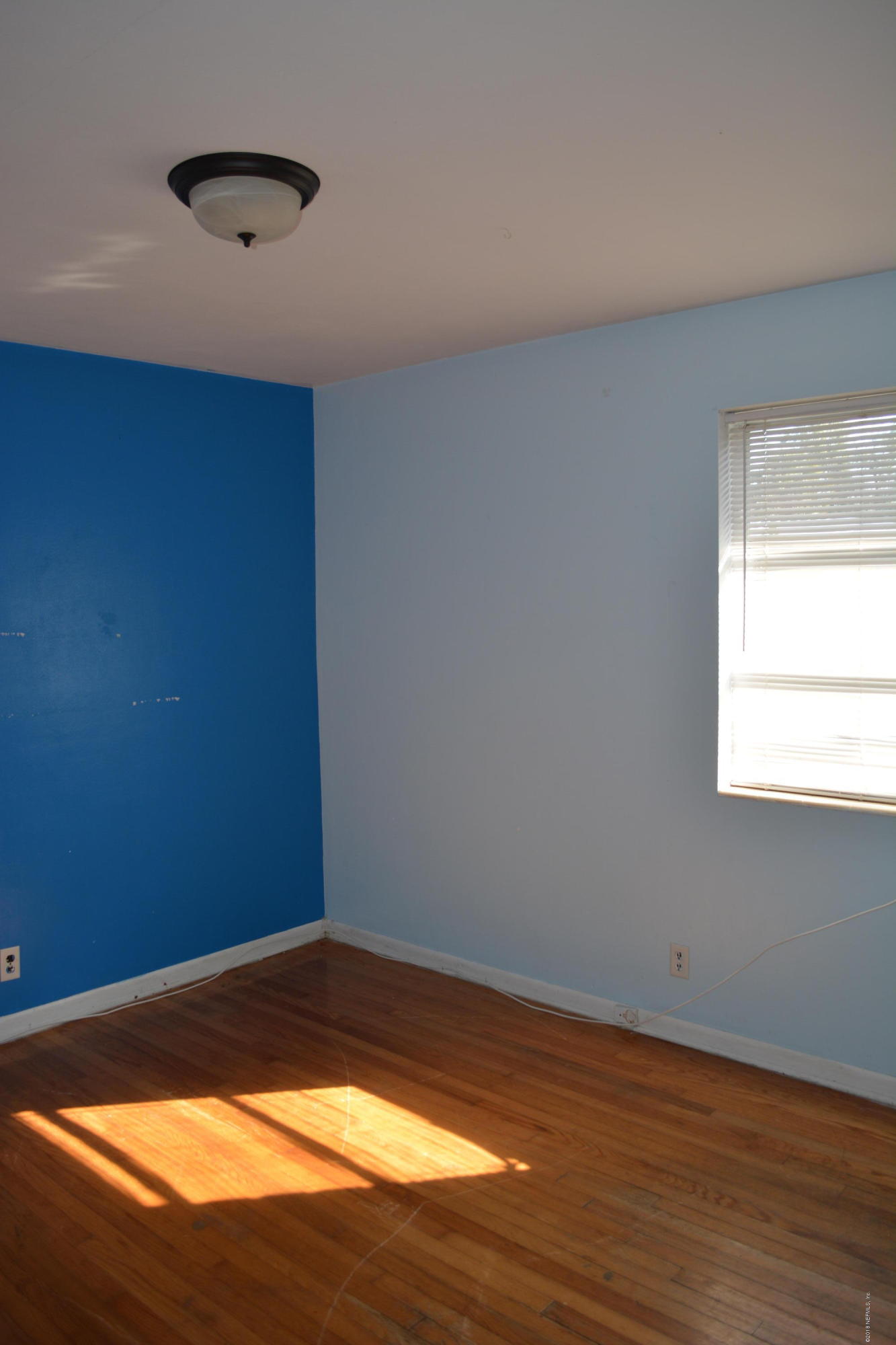 3235 Rogero Road Jacksonville, FL 32277 - Photo 12 of 20 a view of empty room with wooden floor