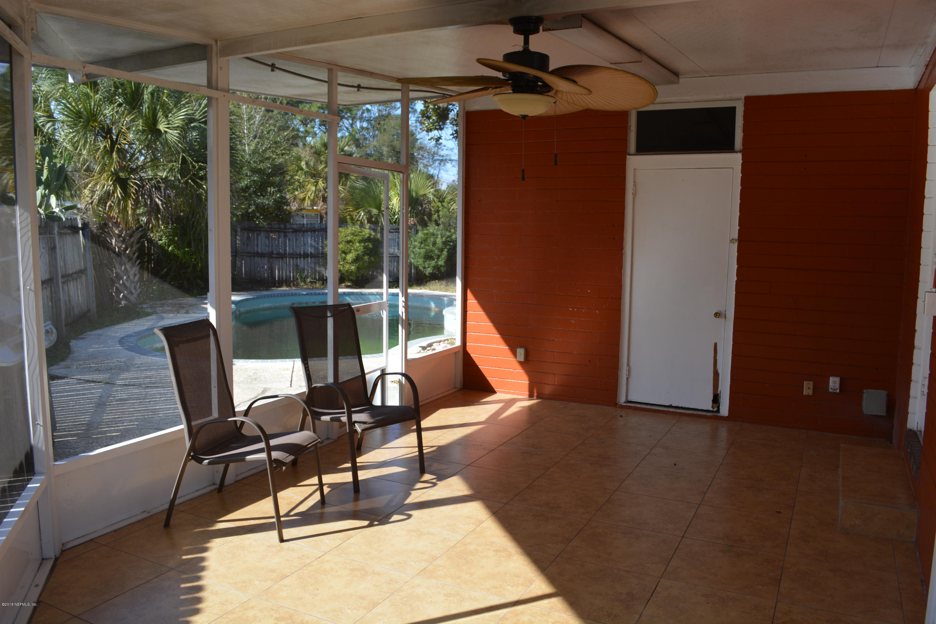 3235 Rogero Road Jacksonville, FL 32277 - Photo 16 of 20 a living room with patio furniture