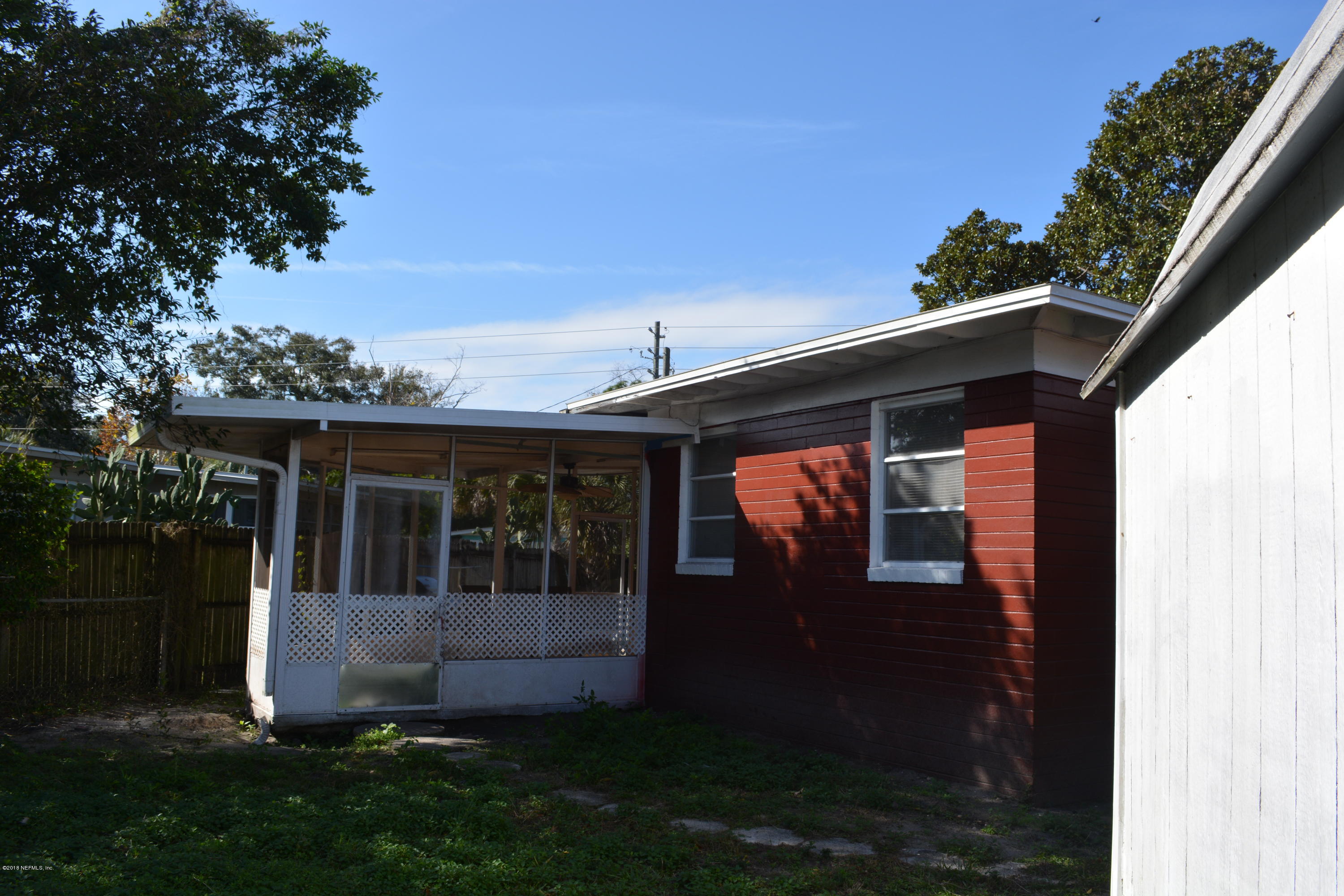 3235 Rogero Road Jacksonville, FL 32277 - Photo 18 of 20 a view of house with backyard and garden
