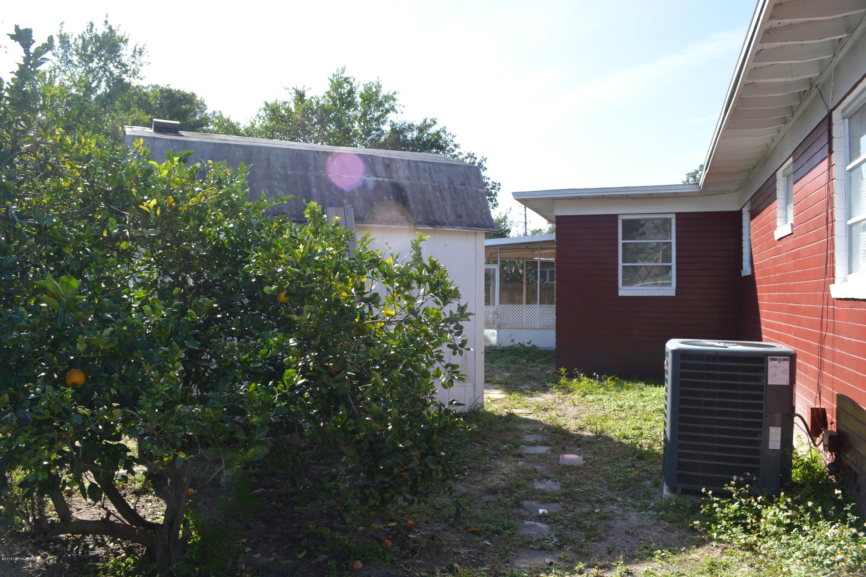 3235 Rogero Road Jacksonville, FL 32277 - Photo 19 of 20 a backyard of a house with lots of green space