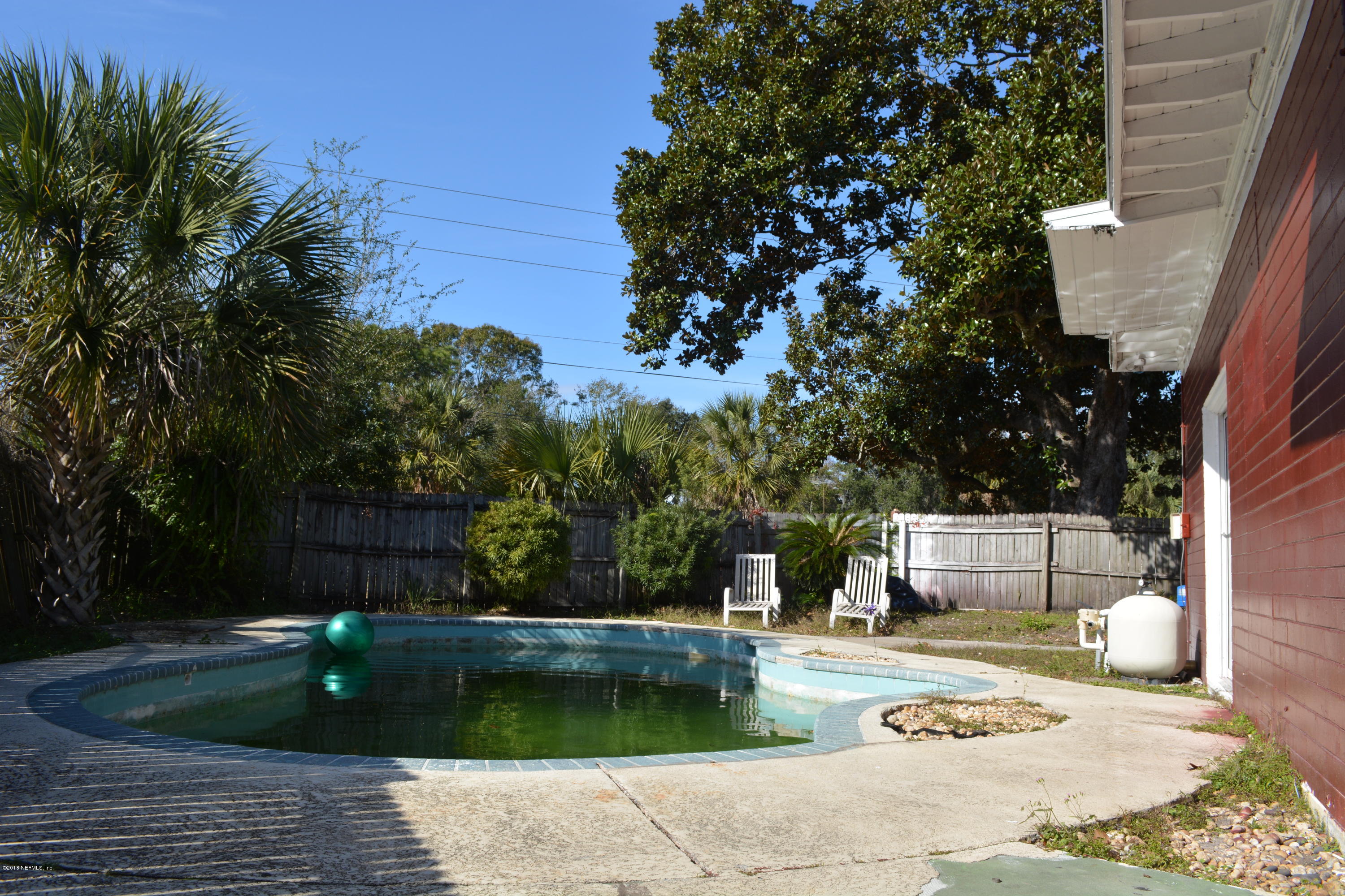 3235 Rogero Road Jacksonville, FL 32277 - Photo 20 of 20 a view of a swimming pool with a patio