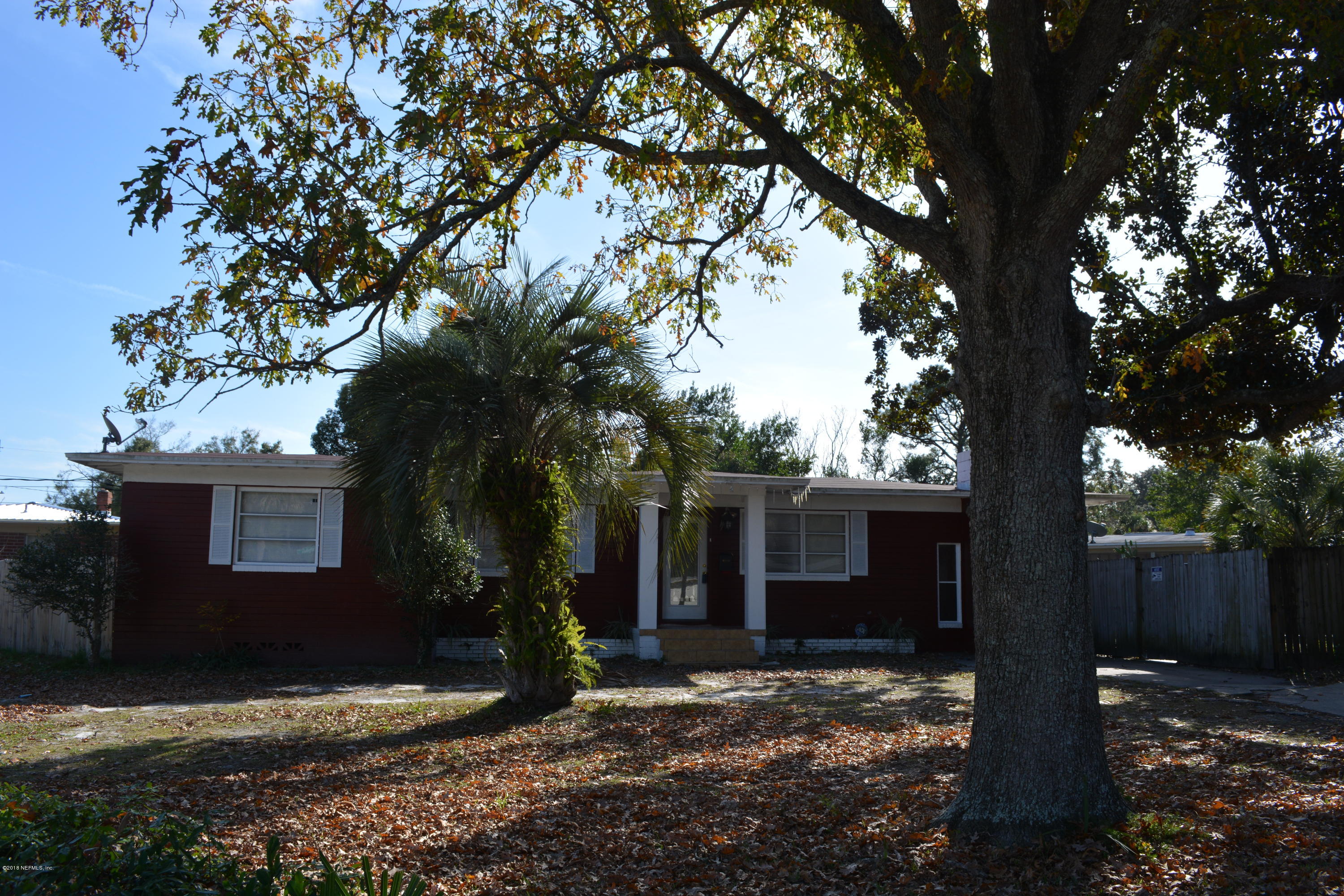 3235 Rogero Road Jacksonville, FL 32277 - Photo 2 of 20 a view of a house with a tree in the background