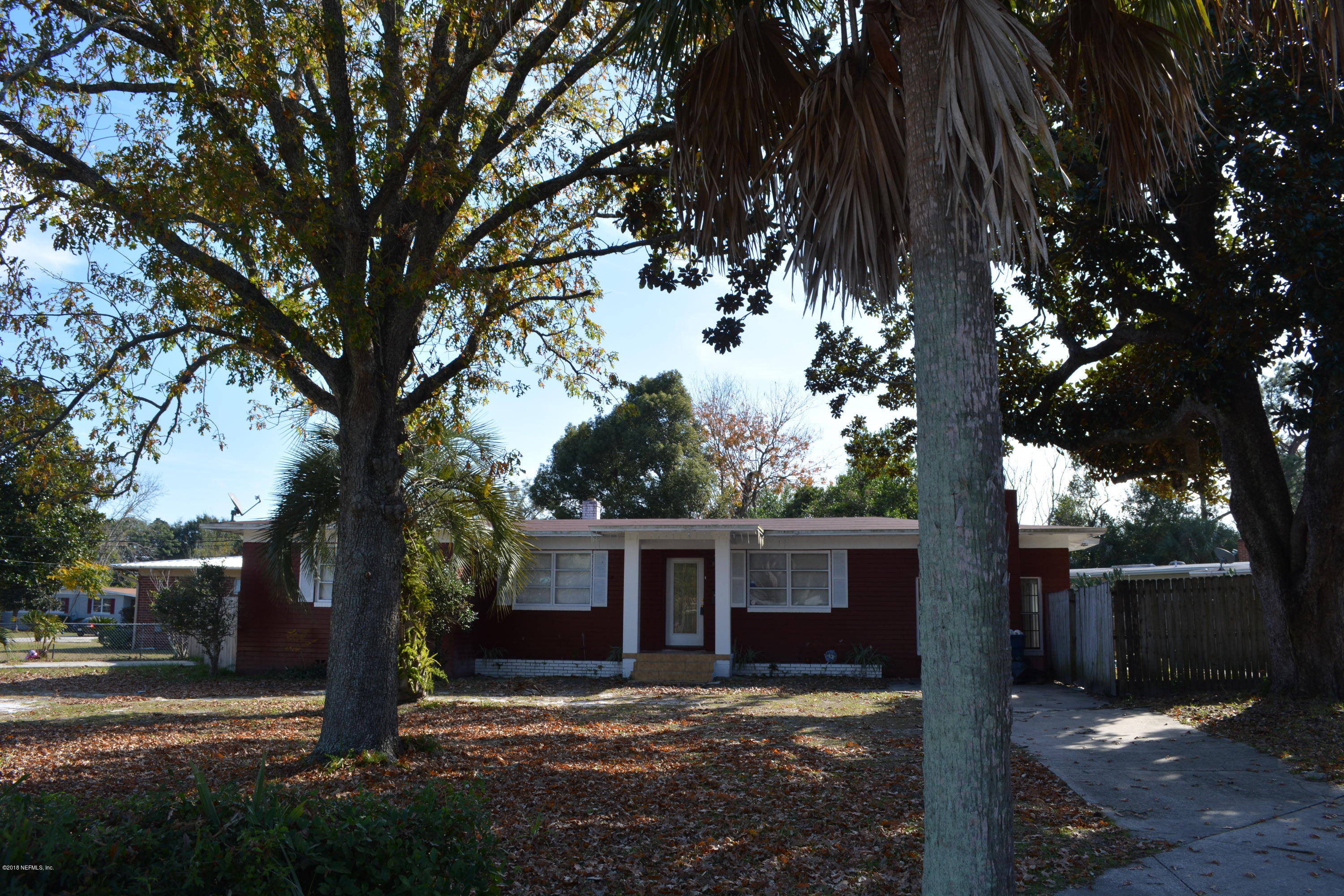 3235 Rogero Road Jacksonville, FL 32277 - Photo 3 of 20 a view of a house with a large tree