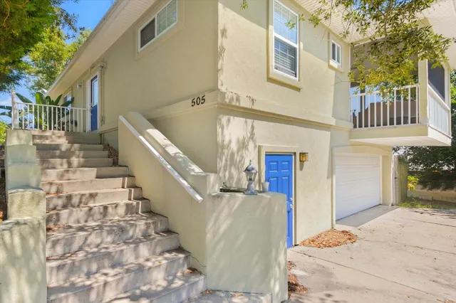 an aerial view of residential houses with outdoor space and swimming pool