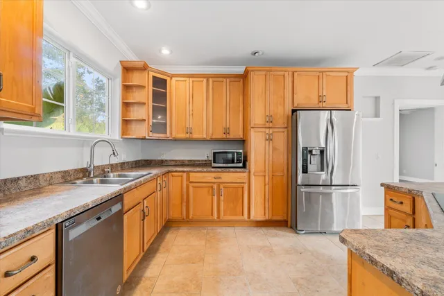 a kitchen with granite countertop a sink and cabinets