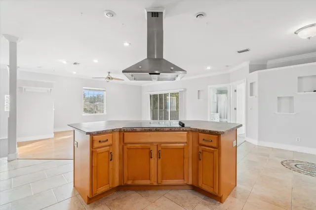 a kitchen with stainless steel appliances granite countertop a stove a sink and a refrigerator