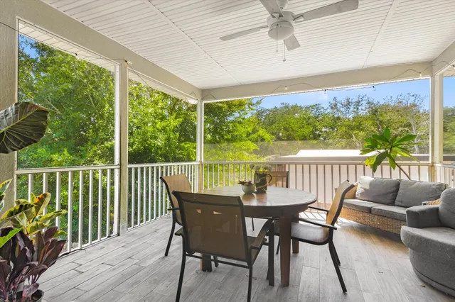 a view of a dining room and livingroom with furniture wooden floor and a chandelier