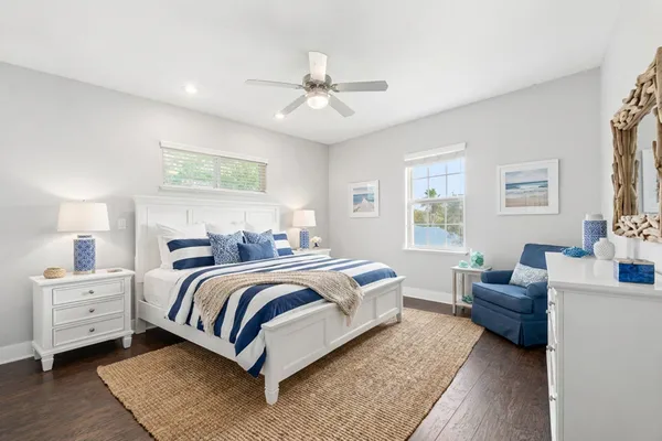 an empty room with wooden floor and ceiling fan