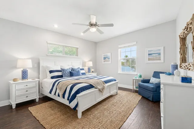 an empty room with wooden floor and ceiling fan