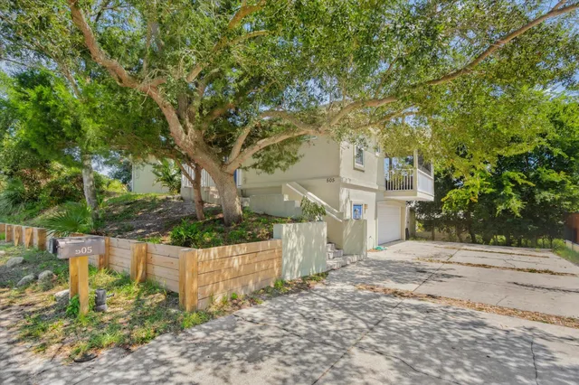 a view of a backyard with large trees
