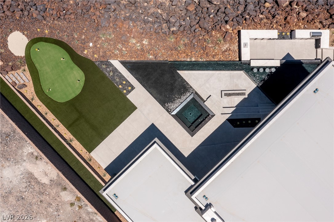 563 Grand Rim Drive Henderson, NV 89012 - Photo 64 of 70 An aerial perspective showcases a meticulously designed putting green, water features, and expansive patio spaces for outdoor enjoyment.