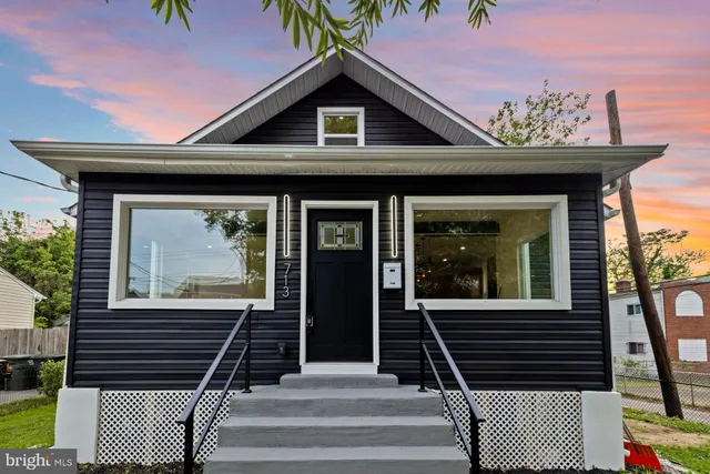 a view of a house with entryway and wooden floor