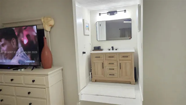 a bathroom with a sink a vanity and mirror