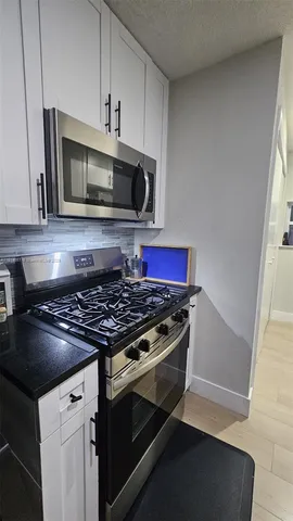 a kitchen with a stove and a microwave