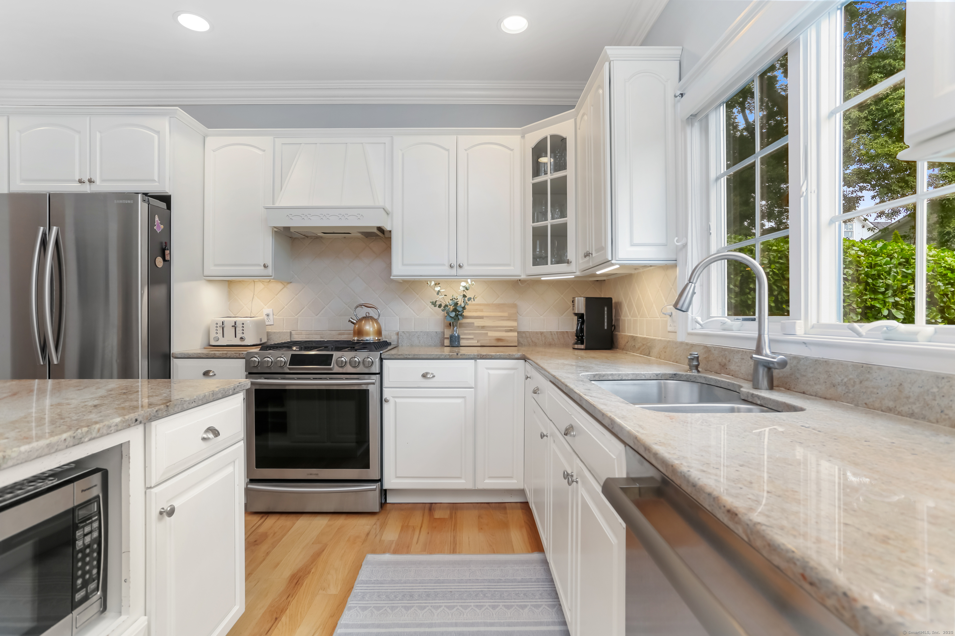 162 Country Road, Unit 162 Fairfield, CT 06824 - Photo 13 of 33 a kitchen with granite countertop a sink stove and refrigerator