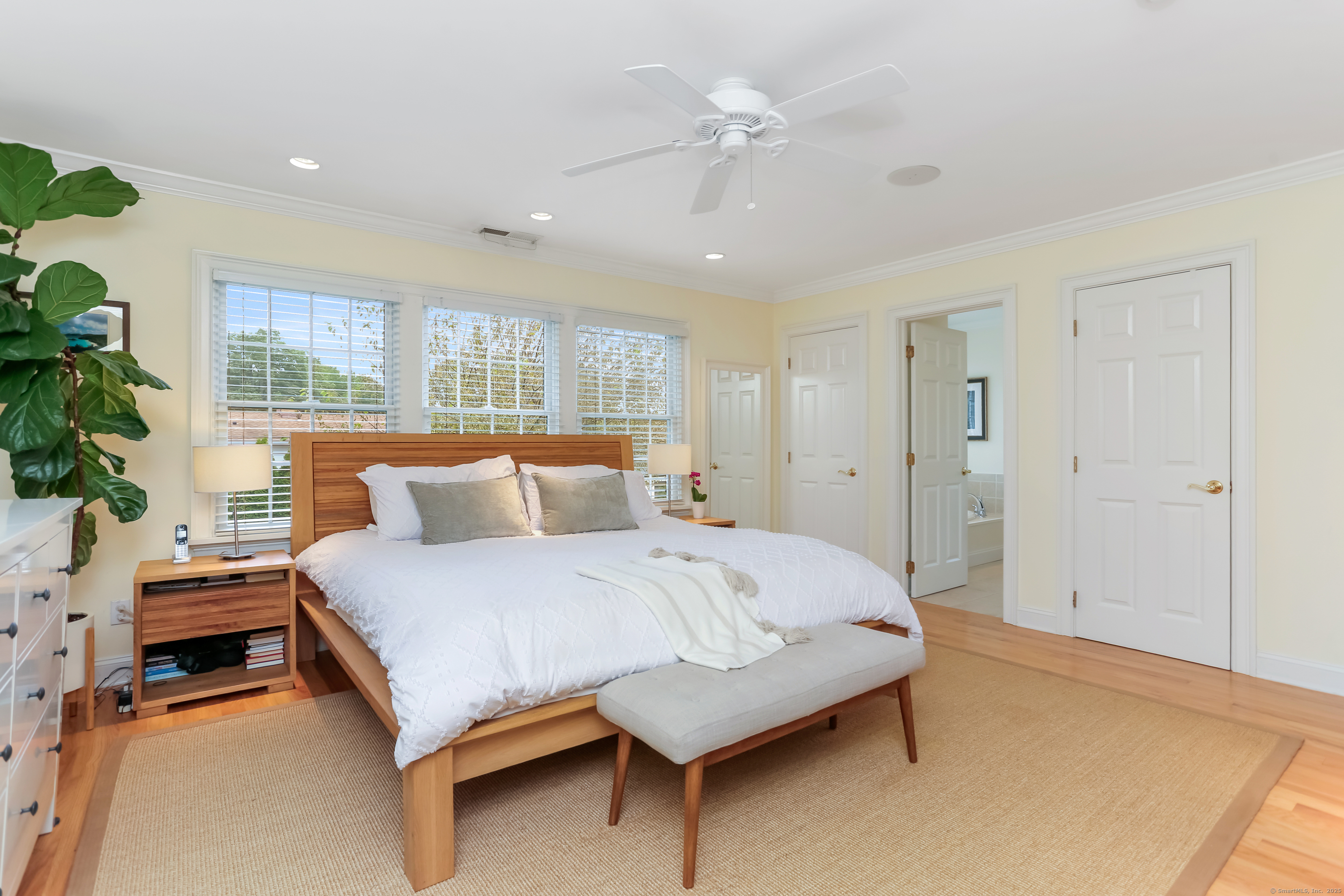 162 Country Road, Unit 162 Fairfield, CT 06824 - Photo 15 of 33 a bedroom with a large bed and a chandelier