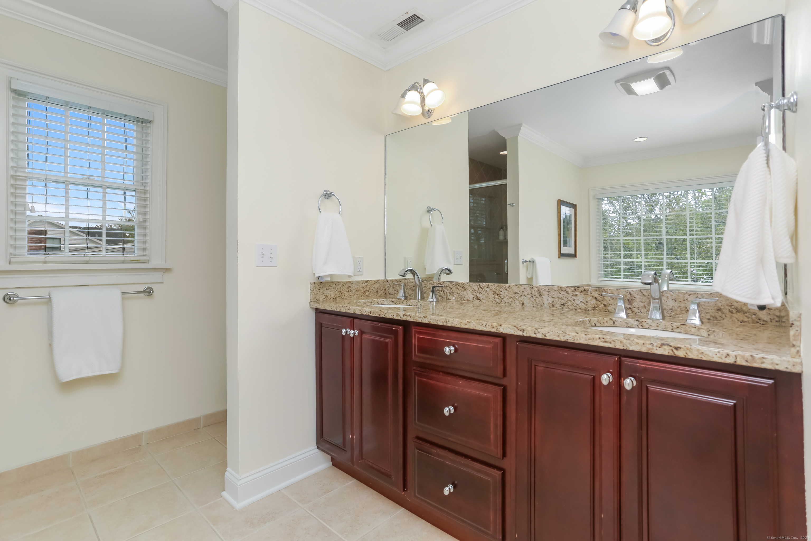 162 Country Road, Unit 162 Fairfield, CT 06824 - Photo 16 of 33 a bathroom with a granite countertop sink and a mirror