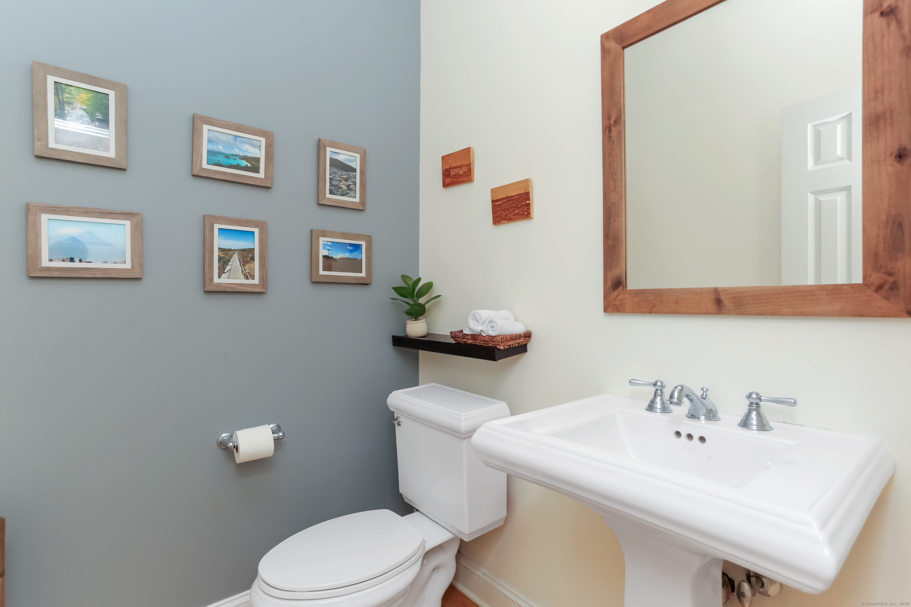 162 Country Road, Unit 162 Fairfield, CT 06824 - Photo 20 of 33 a bathroom with a sink mirror and toilet