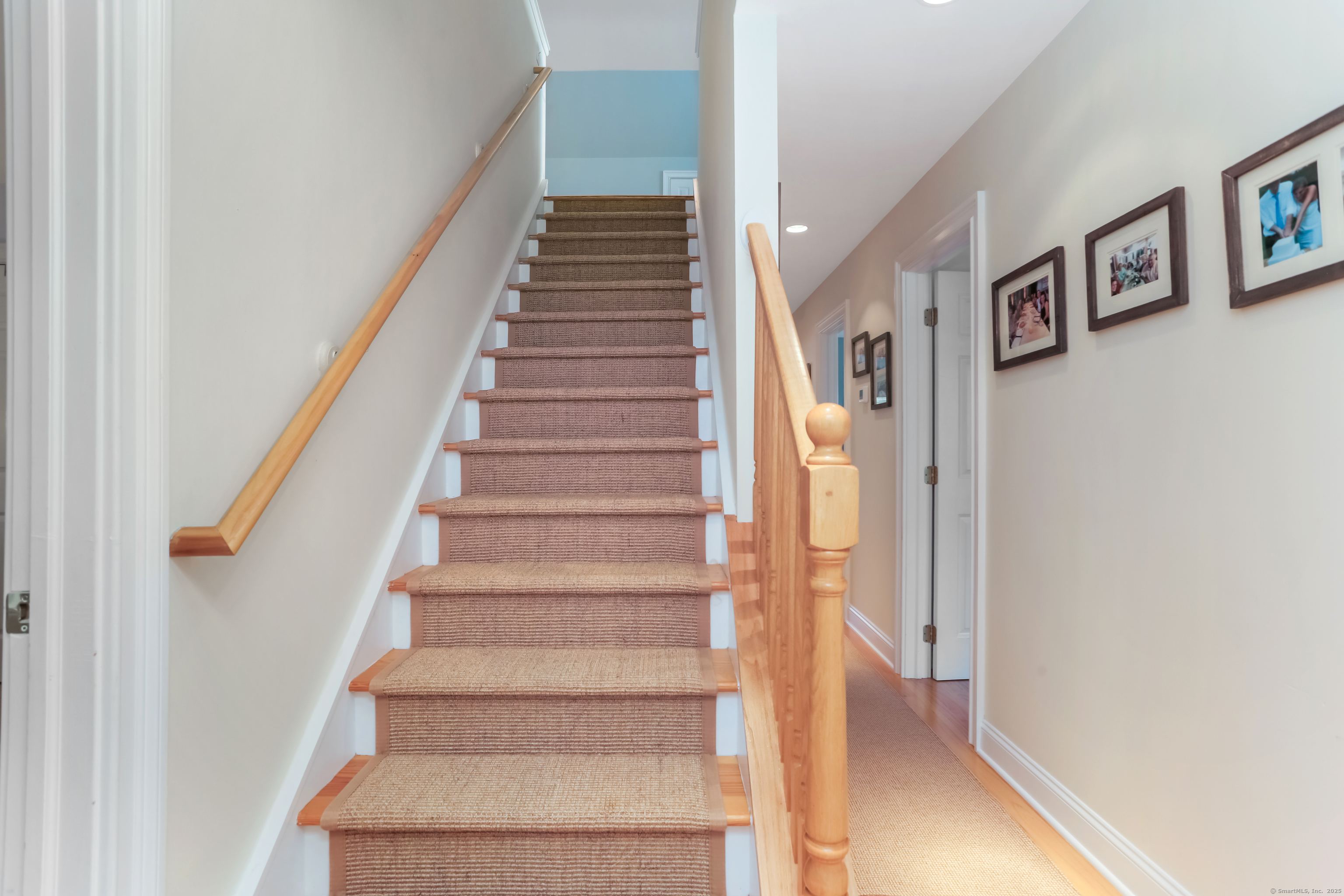 162 Country Road, Unit 162 Fairfield, CT 06824 - Photo 23 of 33 a view of staircase with white walls and black white walls
