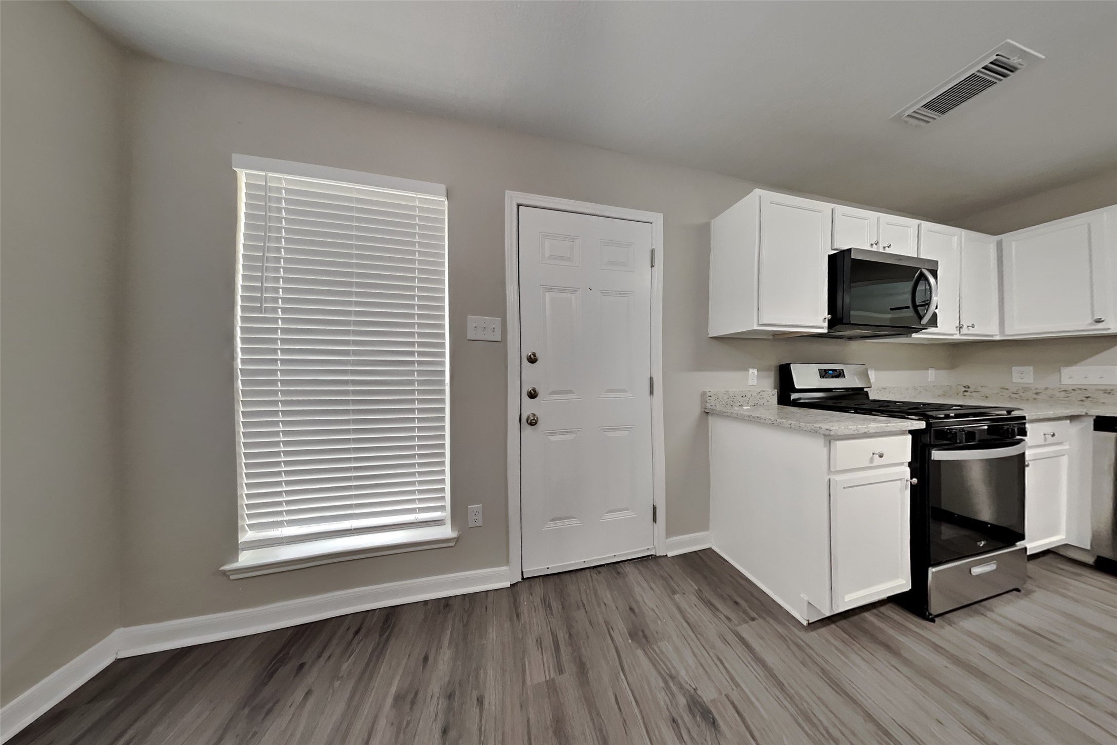 19710 Ringwald Court Spring, TX 77379 - Photo 6 of 20 a kitchen with wooden floors and a stove