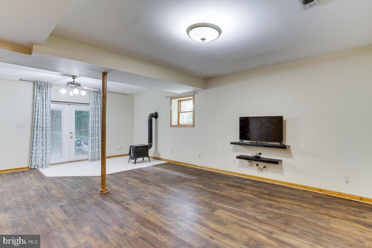 13185 Joy Road Lusby, MD 20657 - Photo 45 of 58 Basement is finished with wood stove- yay!