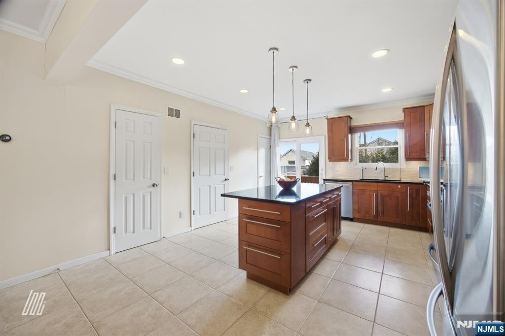 331 Undercliff Avenue Edgewater, NJ 07020 - Photo 14 of 45 a large kitchen with stainless steel appliances granite countertop a stove a sink and a refrigerator