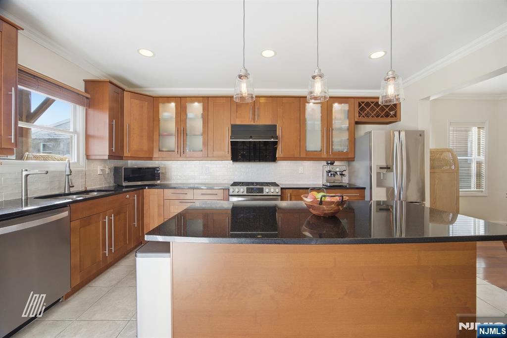 331 Undercliff Avenue Edgewater, NJ 07020 - Photo 15 of 45 a kitchen with stainless steel appliances granite countertop a sink a stove and a refrigerator