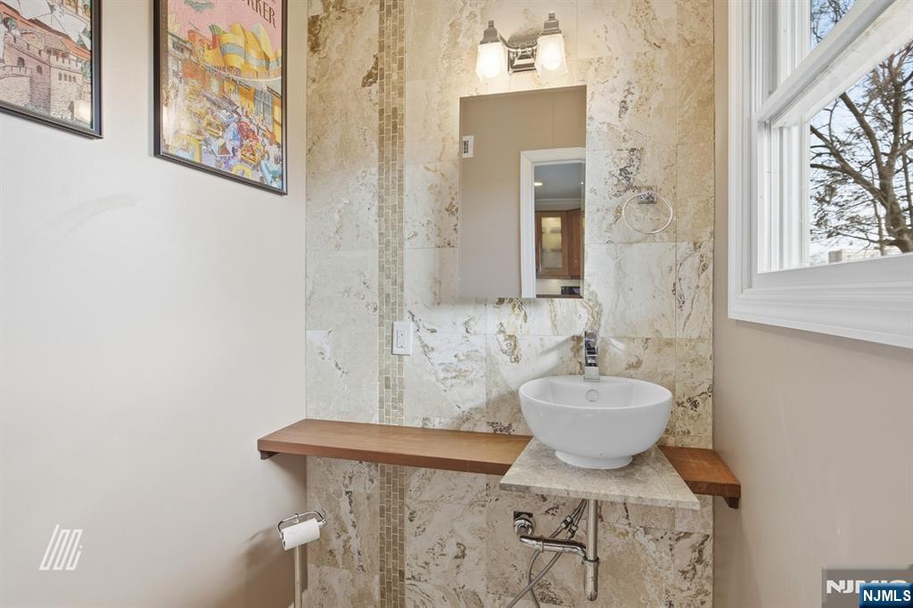 331 Undercliff Avenue Edgewater, NJ 07020 - Photo 18 of 45 a bathroom with a sink a mirror and a toilet