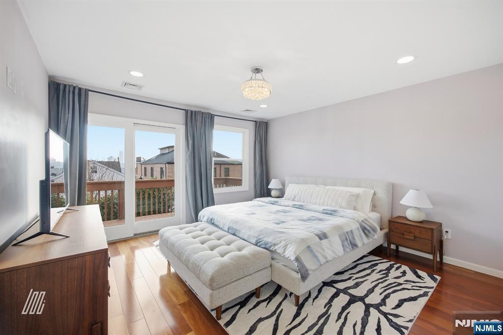 331 Undercliff Avenue Edgewater, NJ 07020 - Photo 23 of 45 a living room with a bed furniture and a large window