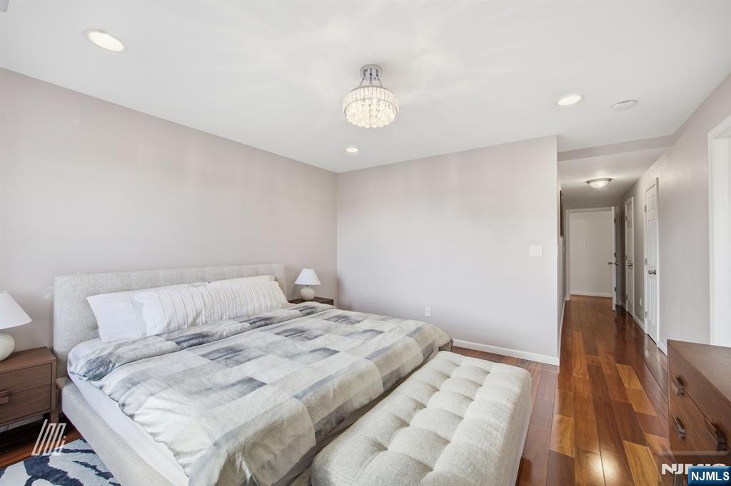 331 Undercliff Avenue Edgewater, NJ 07020 - Photo 24 of 45 a bedroom with a bed and a chandelier