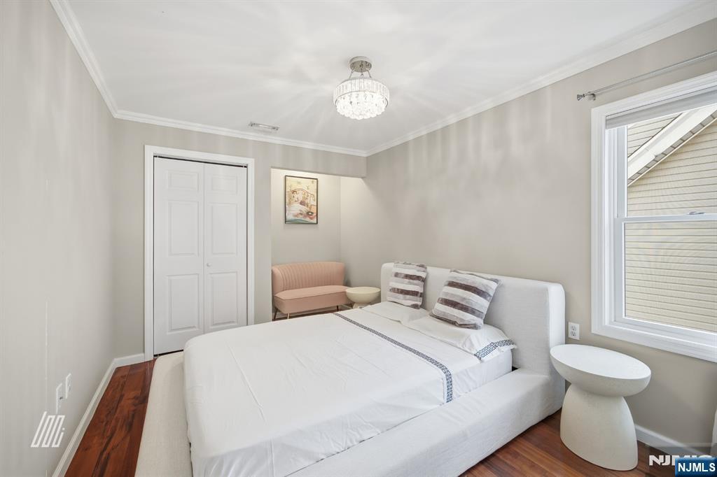 331 Undercliff Avenue Edgewater, NJ 07020 - Photo 30 of 45 a bedroom with a bed and a window