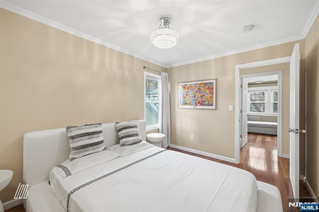 331 Undercliff Avenue Edgewater, NJ 07020 - Photo 31 of 45 a bedroom with a bed and a chandelier