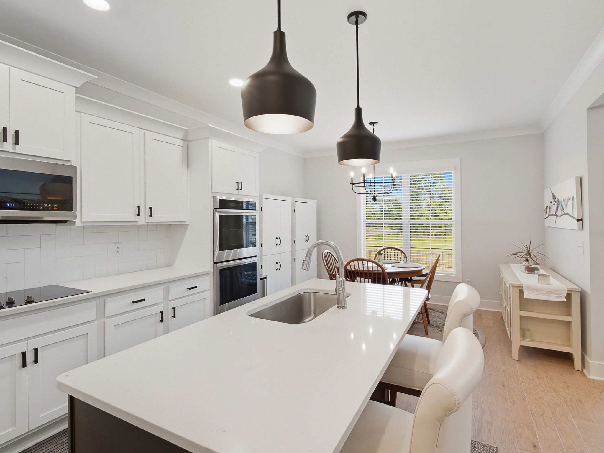 106 Watermill Lane Lebanon, TN 37087 - Photo 20 of 85 a kitchen with stainless steel appliances a stove a sink a dining table and chairs