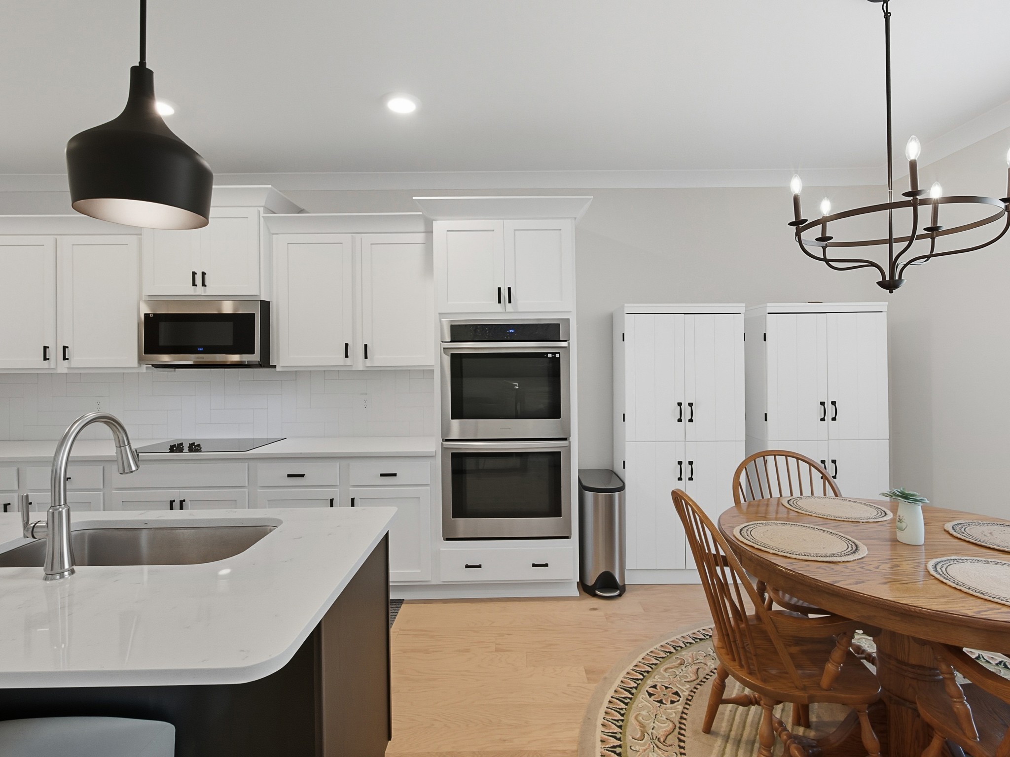 106 Watermill Lane Lebanon, TN 37087 - Photo 23 of 85 a kitchen with stainless steel appliances a sink a microwave a dining table and chairs