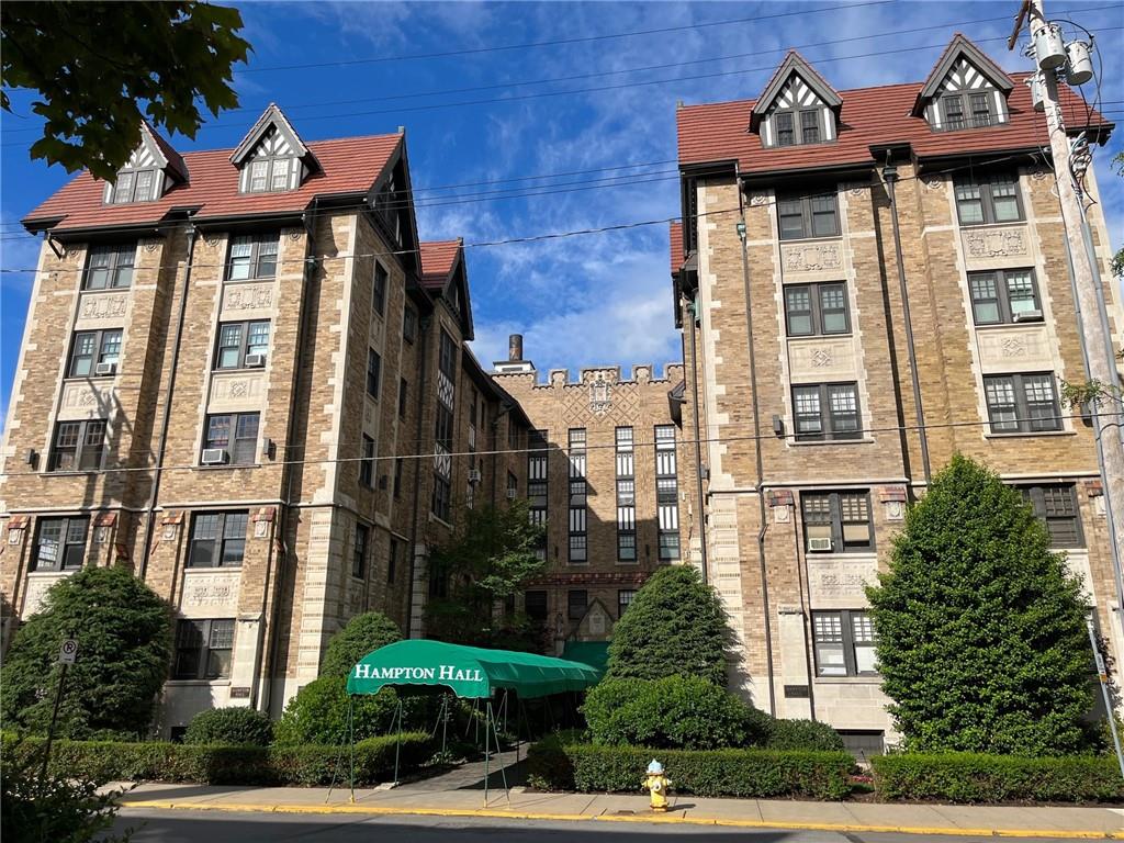 a front view of a residential apartment building with a yard