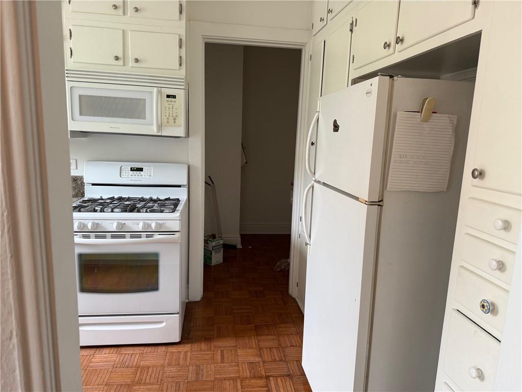 166 North Dithridge Street, Unit 2A Pittsburgh, PA 15213 - Photo 11 of 32 a kitchen with a refrigerator stove and white cabinets