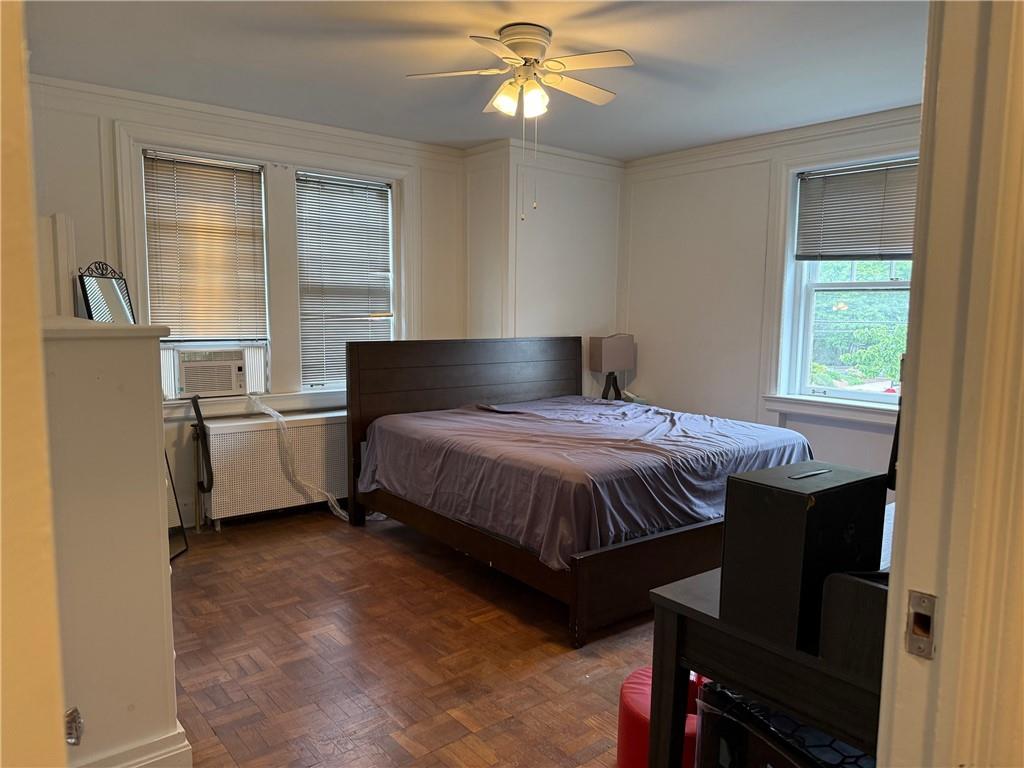 166 North Dithridge Street, Unit 2A Pittsburgh, PA 15213 - Photo 15 of 32 a bedroom with a bed and a chandelier