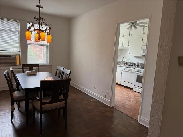 a kitchen with cabinets appliances and a window