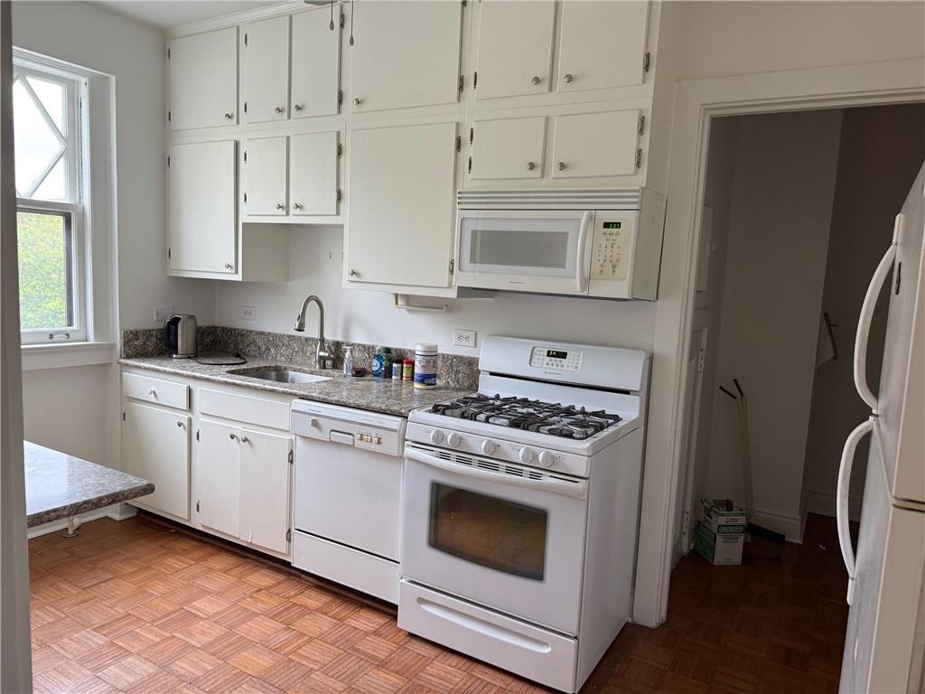 166 North Dithridge Street, Unit 2A Pittsburgh, PA 15213 - Photo 10 of 32 a kitchen with cabinets appliances and a window