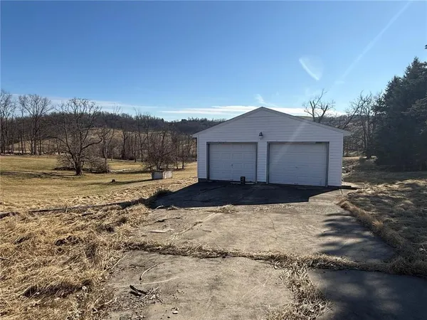 a view of a house with a yard covered in snow