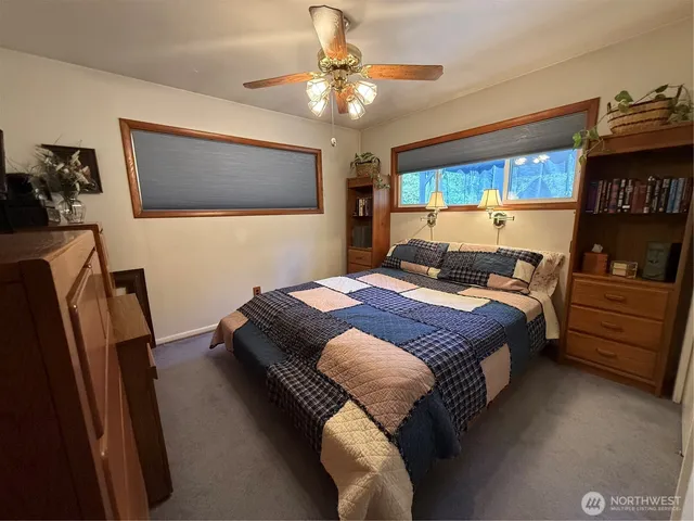 a bedroom with a bed and dresser