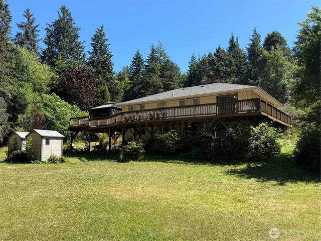 a view of a house with yard and sitting area