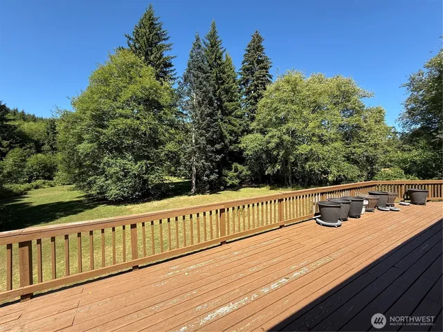 a view of a roof deck with wooden floor and fence