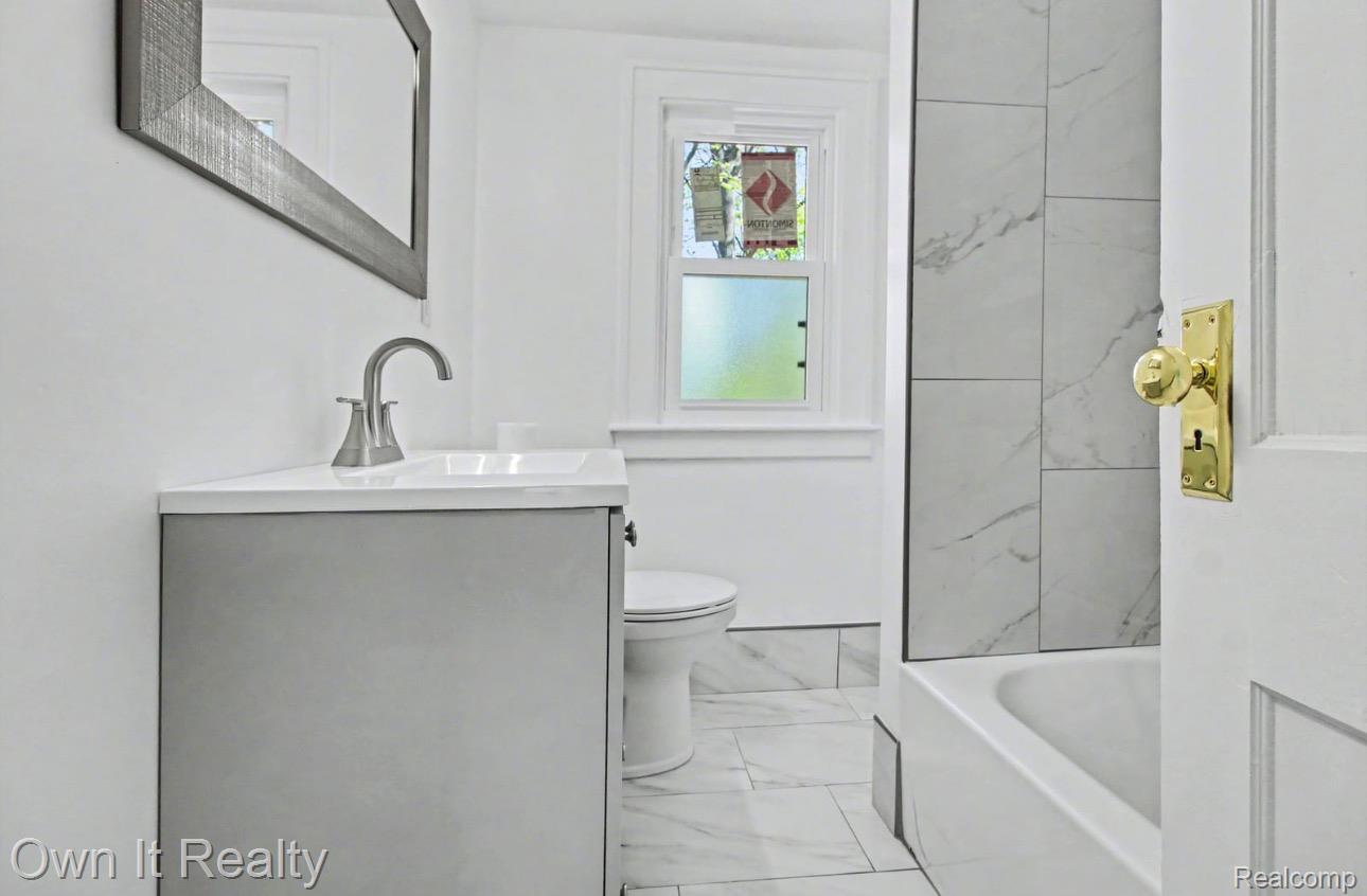 6023 Wayne Road Romulus, MI 48174 - Photo 13 of 25 Full bathroom with vanity, a tub to relax in, light marble finish floors, and a shower