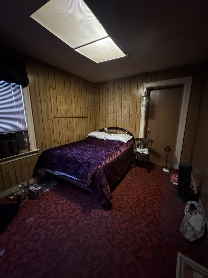 8239 South Ridgeland Avenue Chicago, IL 60617 - Photo 9 of 16 a bed sitting in a room next to a window
