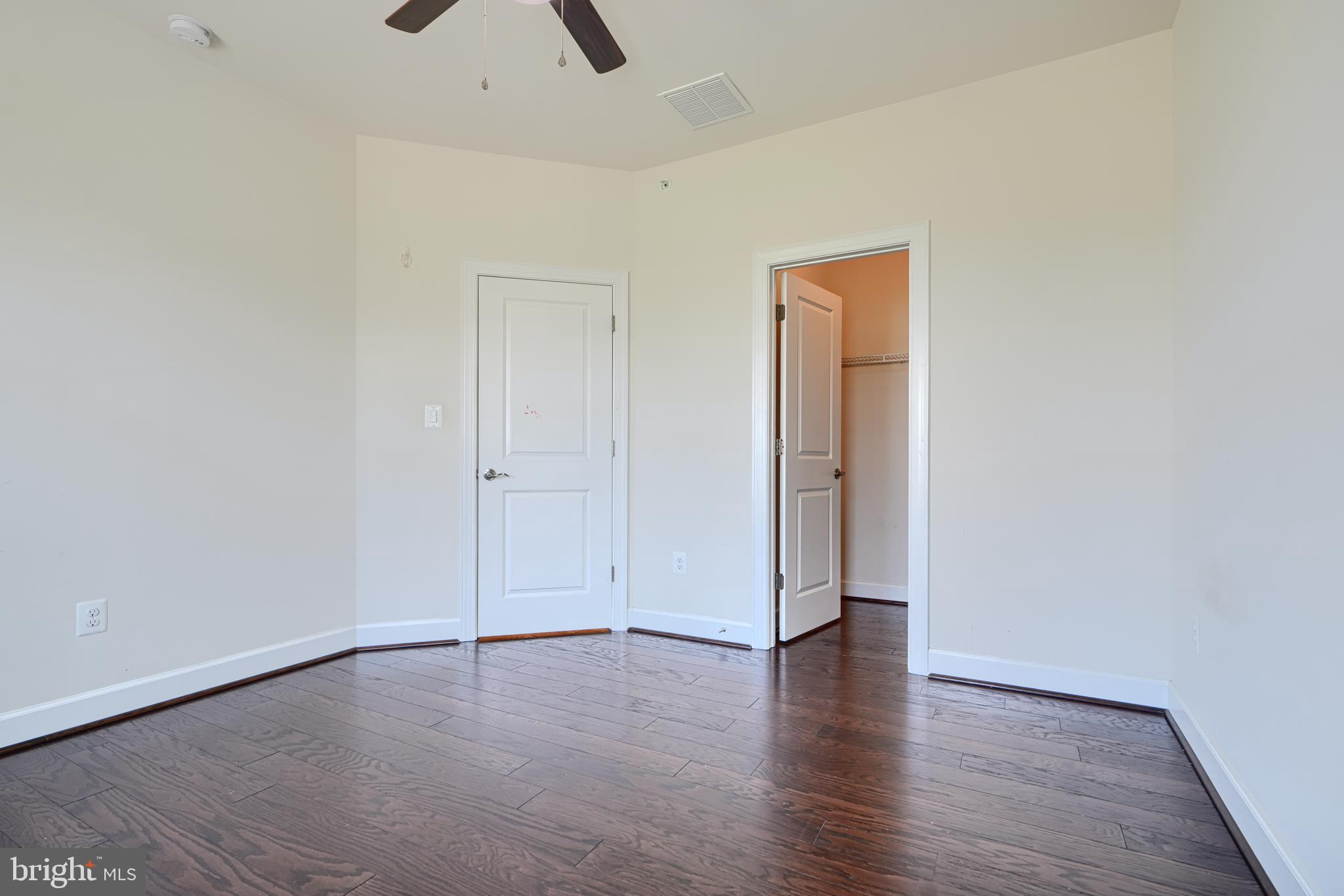 10819 White Trillium Road Perry Hall, MD 21128 - Photo 25 of 47 an empty room with wooden floor and closet