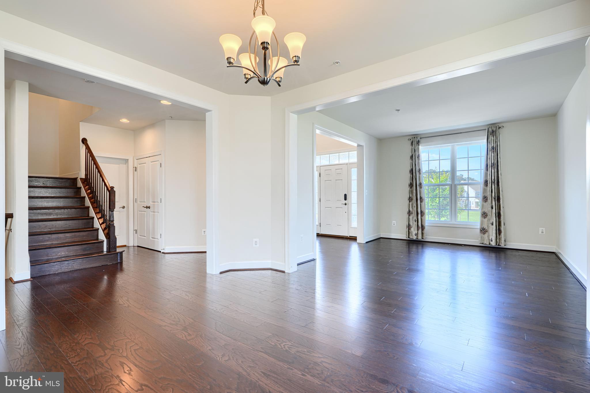10819 White Trillium Road Perry Hall, MD 21128 - Photo 8 of 47 a view of a livingroom with wooden floor and stairs